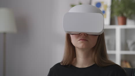 young-woman-with-new-model-of-head-mounted-display-for-virtual-reality-medium-portrait-of-woman-with-HMD-indoors-modern-technology